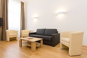 black leather sofa with 3 stools in the apartment Vienna
