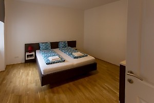 Schlafzimmer mit Doppelbett und blauer Bettwäsche in Wien