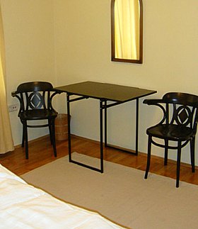 sleeping room and small table with two chairs