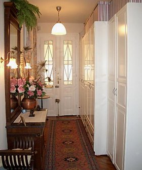 hall with tall white wardrobes