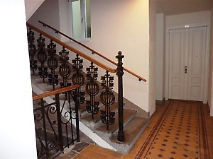 a delightful banister with big white doors