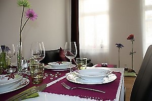 ein sehr schön gedeckter Tisch mit lila Elementen